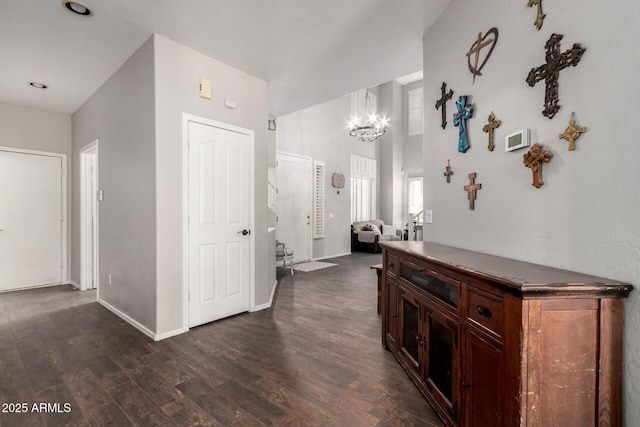 6862 W Honeysuckle Dr, Peoria, AZ 85383 - corridor featuring dark wood-style flooring, a chandelier, and baseboards