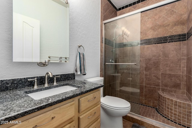 6862 W Honeysuckle Dr, Peoria, AZ 85383 - bathroom with a textured wall, vanity, toilet, and a stall shower