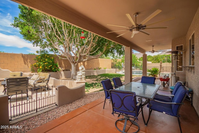 6862 W Honeysuckle Dr, Peoria, AZ 85383 - fenced backyard with ceiling fan, a patio, outdoor dining area, and an outdoor hangout area
