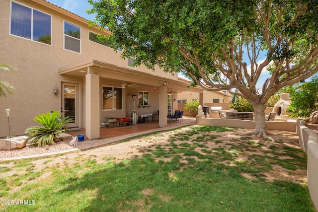 6862 W Honeysuckle Dr, Peoria, AZ 85383 - view of grassy yard with a ceiling fan, area for grilling, and a patio area
