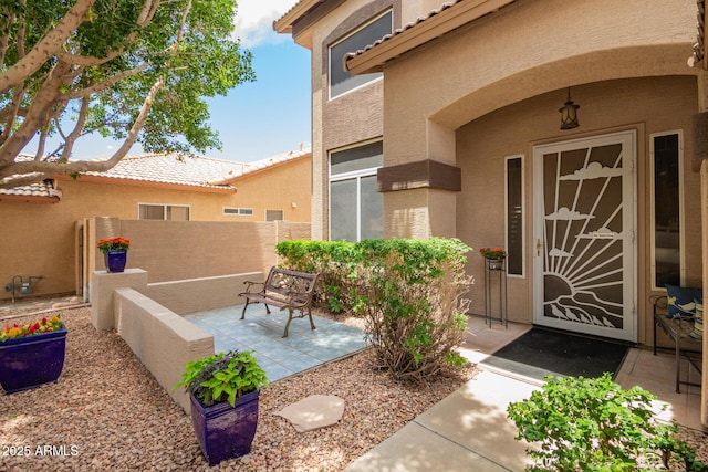 6862 W Honeysuckle Dr, Peoria, AZ 85383 - property entrance featuring stucco siding, a tile roof, and a patio area