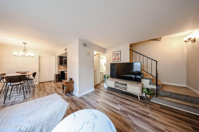 living room featuring a notable chandelier and wood-type flooring