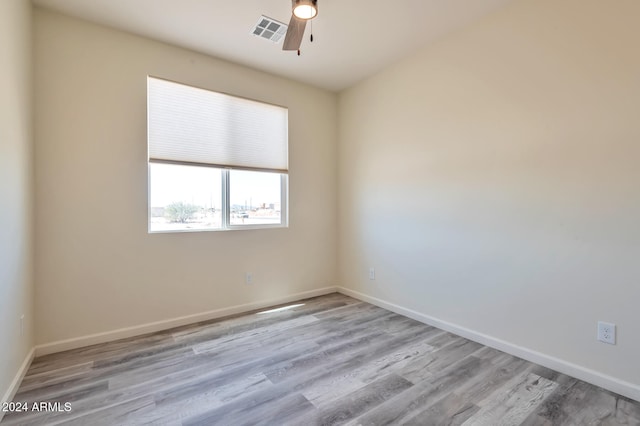 unfurnished room with light wood-type flooring and ceiling fan