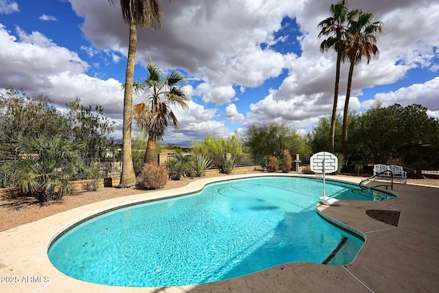 view of pool with a fenced in pool, fence, and a patio