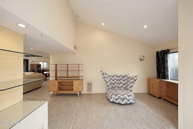 living area featuring recessed lighting, visible vents, and wood finished floors