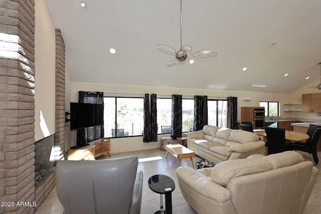 living area featuring ceiling fan, high vaulted ceiling, and recessed lighting