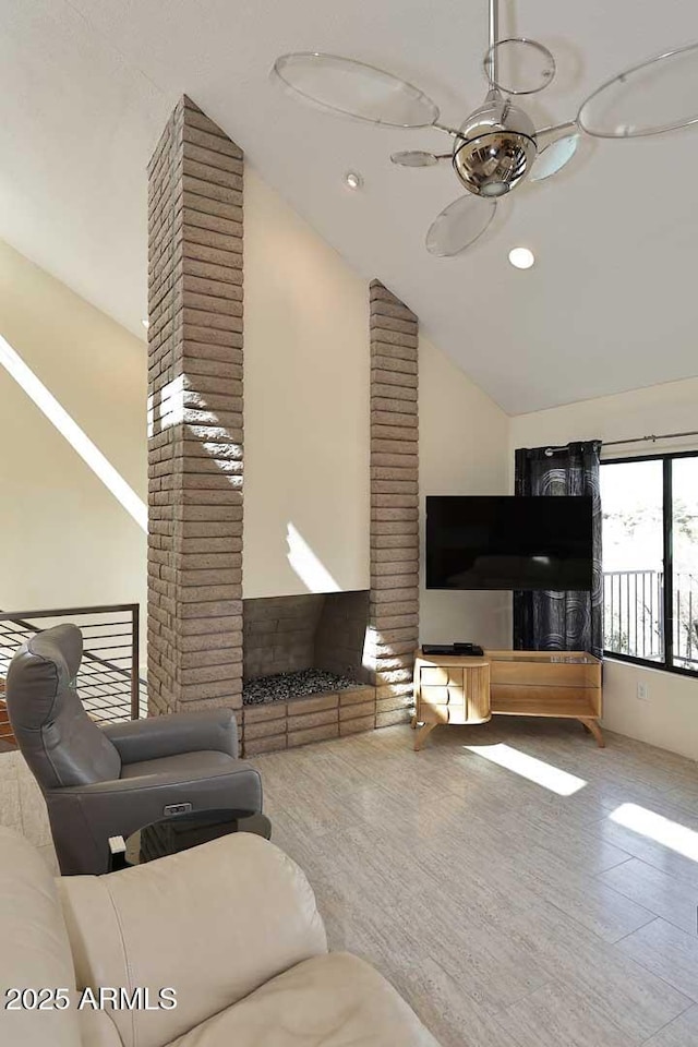 living area featuring lofted ceiling, ceiling fan, and recessed lighting