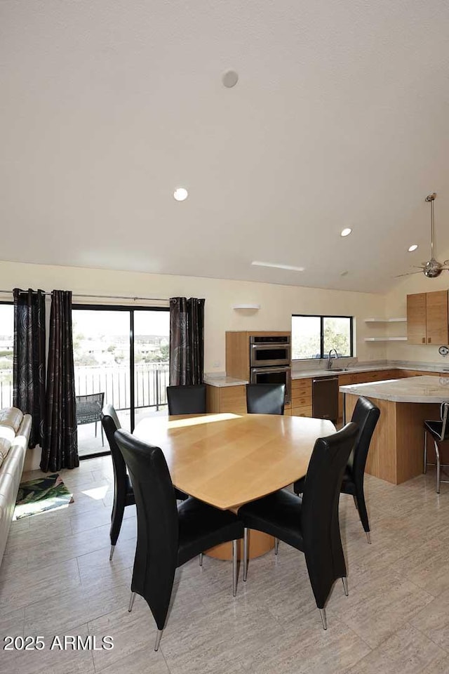 dining area with vaulted ceiling and recessed lighting