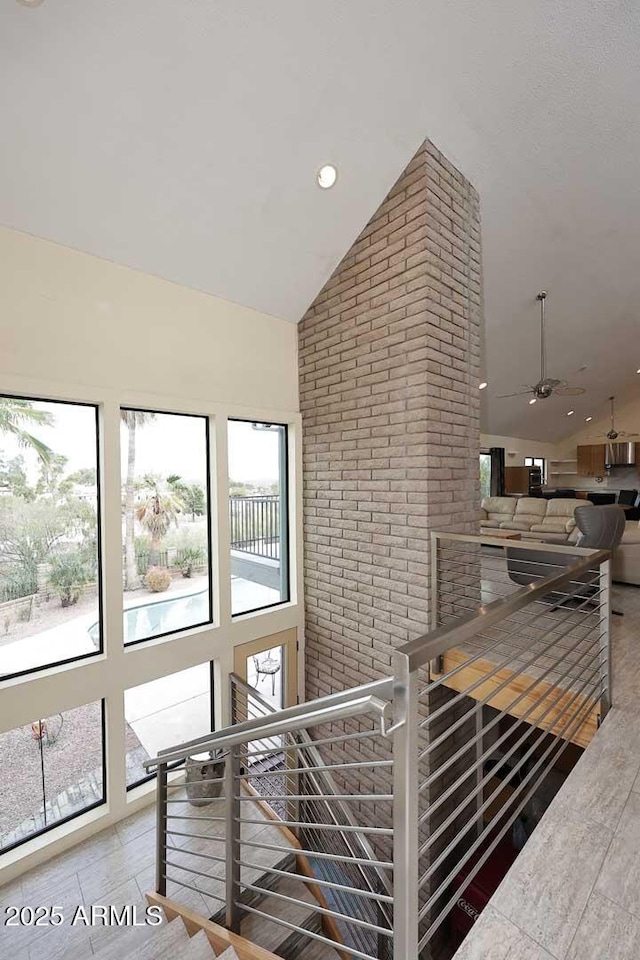 interior space featuring high vaulted ceiling, recessed lighting, an upstairs landing, and a healthy amount of sunlight