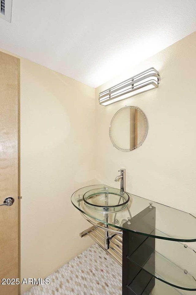 bathroom featuring visible vents and a sink