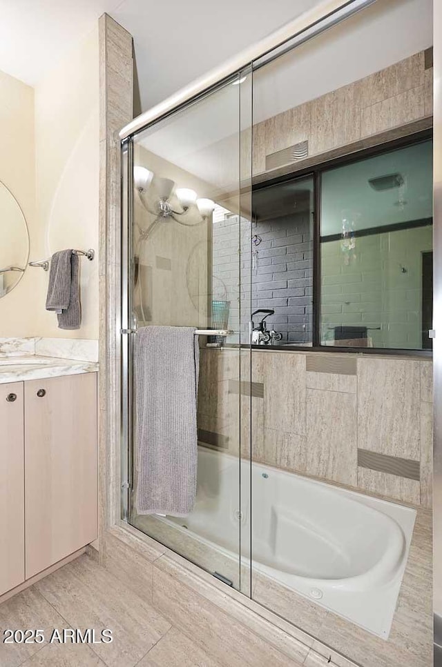 bathroom featuring vanity, a shower stall, and a bath