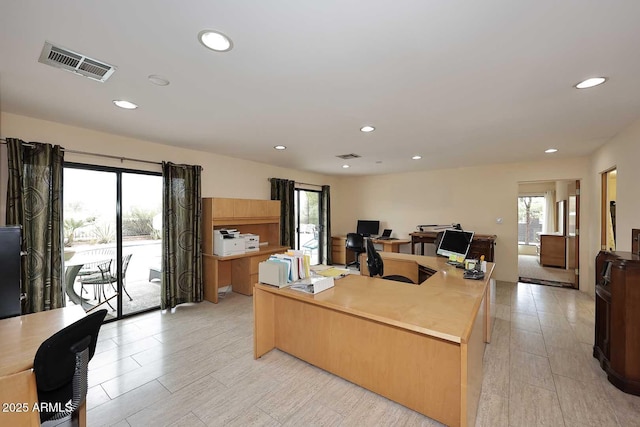 office space featuring light wood-type flooring, visible vents, and recessed lighting