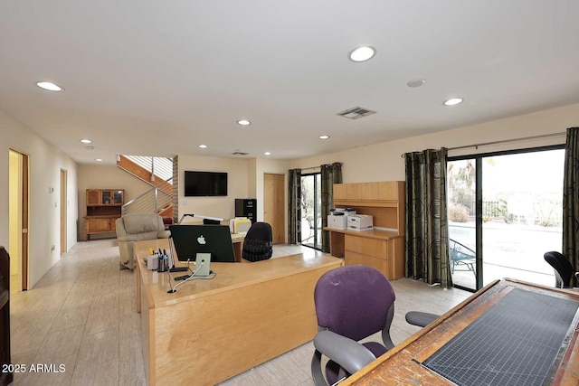 office space with light wood-type flooring, visible vents, and recessed lighting