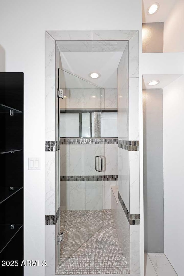 full bathroom featuring marble finish floor, a shower stall, and recessed lighting