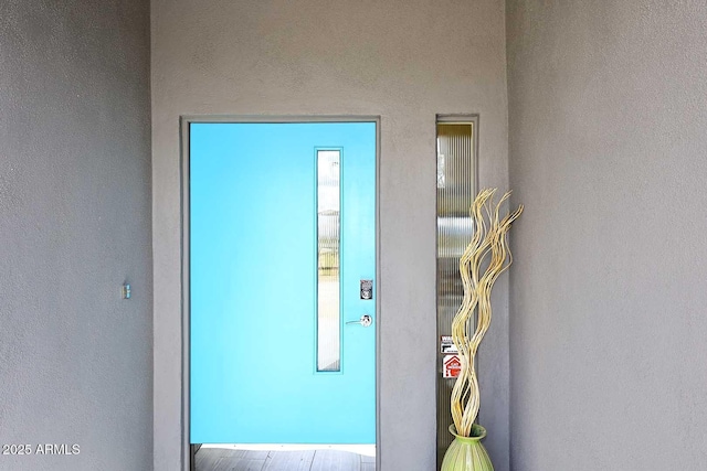 entrance to property featuring stucco siding