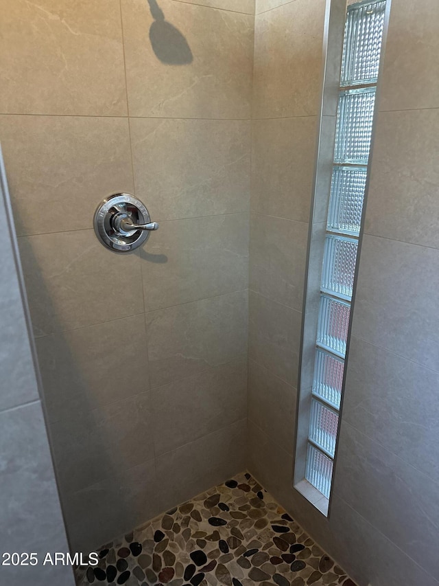 bathroom with a tile shower