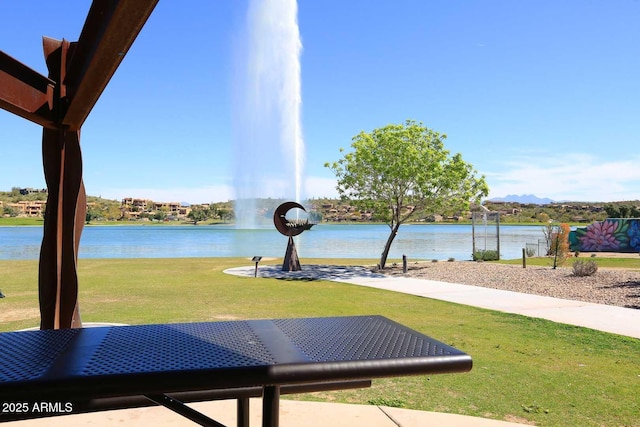 view of community with a water view and a lawn