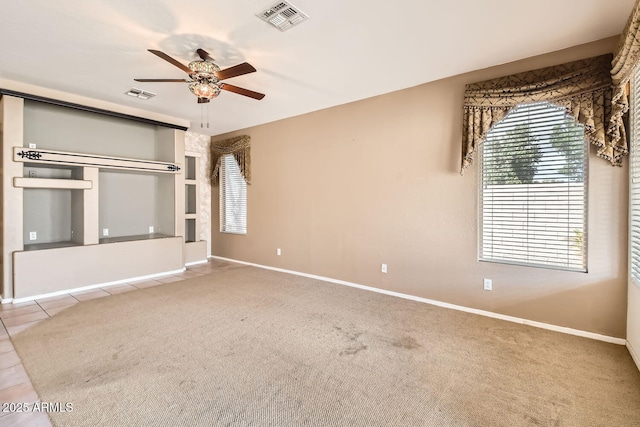 unfurnished bedroom with tile patterned flooring, baseboards, visible vents, and carpet flooring