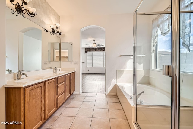 full bathroom with a ceiling fan, a sink, a bath, and tile patterned floors