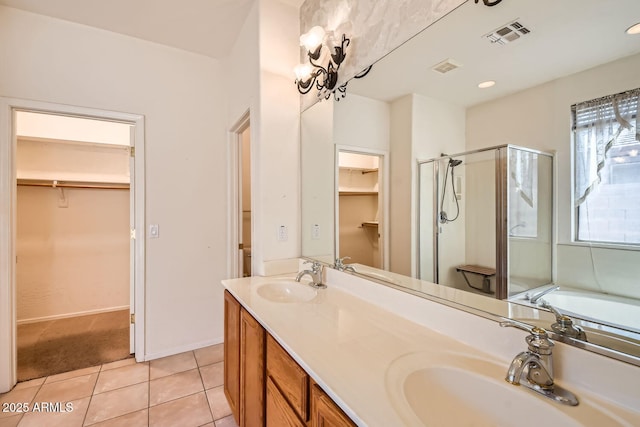 full bathroom featuring tile patterned flooring, visible vents, a sink, and a shower stall