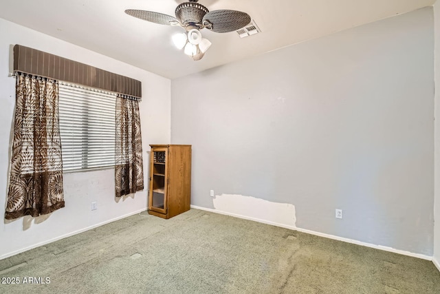 unfurnished room with a ceiling fan, carpet flooring, visible vents, and baseboards