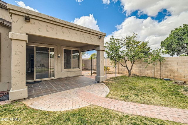 view of yard with a patio area and a fenced backyard