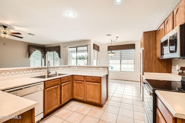 kitchen with a sink, visible vents, electric range oven, stainless steel microwave, and dishwasher