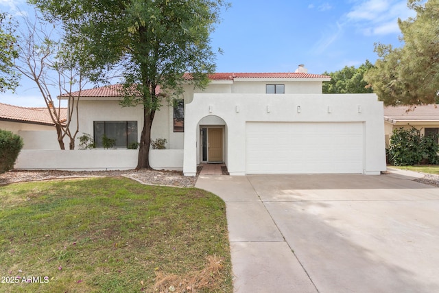 mediterranean / spanish house with stucco siding, a tile roof, concrete driveway, an attached garage, and a chimney