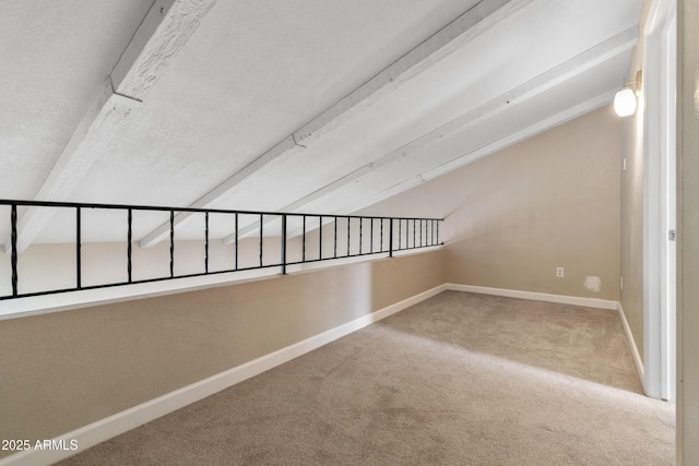 interior space featuring vaulted ceiling and baseboards