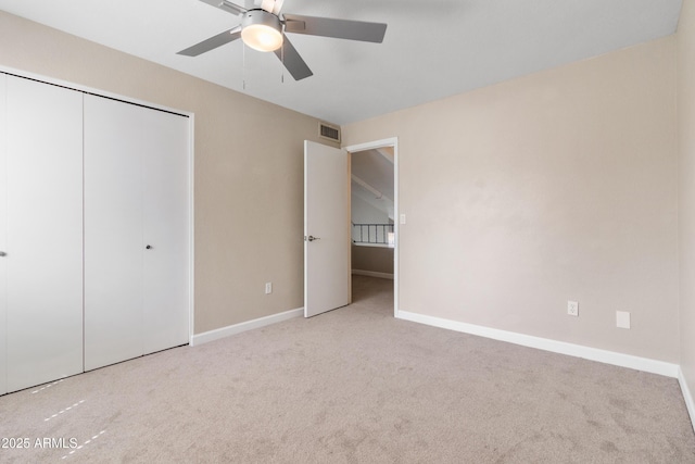 unfurnished bedroom with a closet, baseboards, visible vents, and carpet flooring