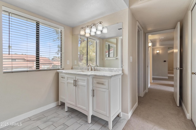 bathroom with baseboards and vanity