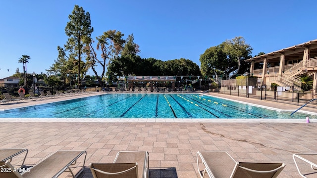 community pool featuring a patio area and fence