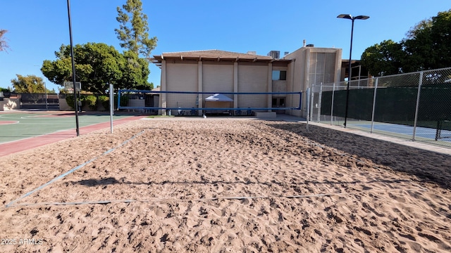 surrounding community featuring community basketball court, volleyball court, and fence