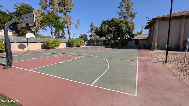 view of basketball court featuring community basketball court and fence