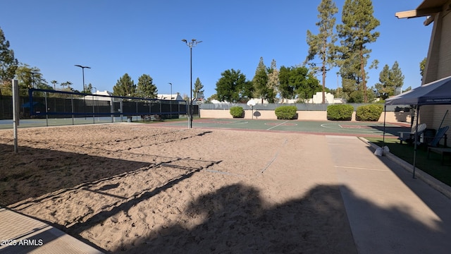 view of community featuring community basketball court, fence, and volleyball court