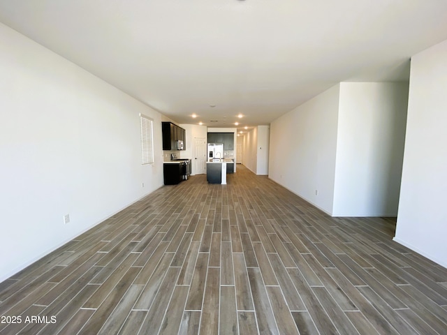 unfurnished living room featuring recessed lighting and wood tiled floor