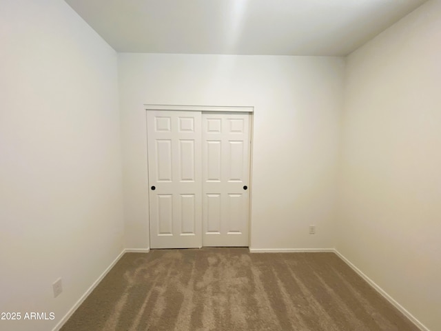 empty room with carpet floors and baseboards