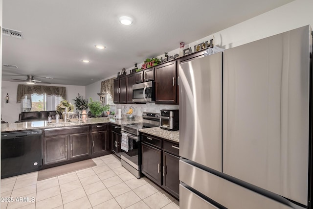 kitchen featuring light stone counters, light tile patterned floors, visible vents, dark brown cabinets, and appliances with stainless steel finishes