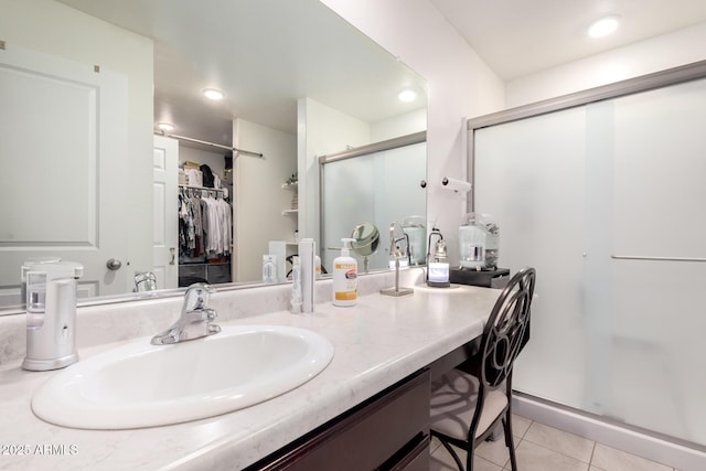 bathroom featuring vanity, recessed lighting, a shower stall, a spacious closet, and tile patterned floors