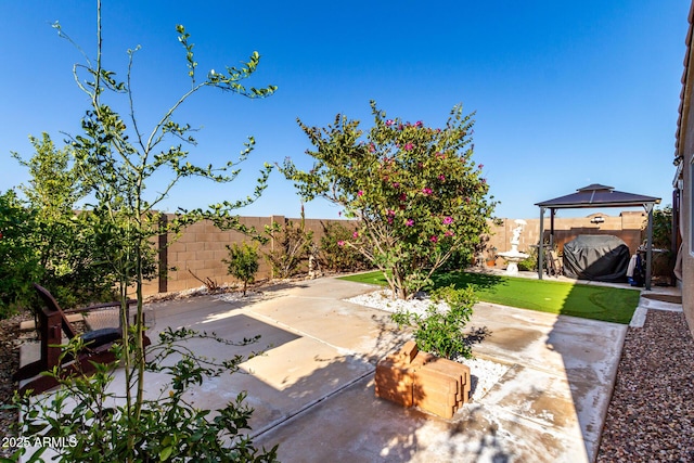 view of patio / terrace with a gazebo and a fenced backyard