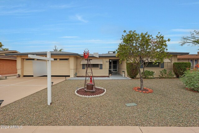 ranch-style home featuring a garage