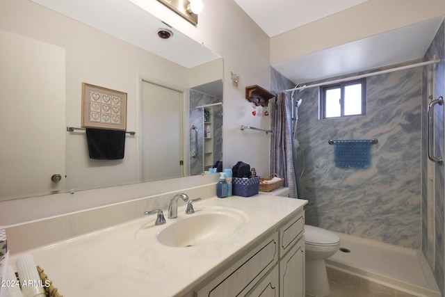 full bath with a stall shower, vanity, toilet, and tile patterned floors