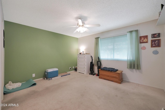 miscellaneous room featuring baseboards, a ceiling fan, a textured ceiling, and carpet flooring