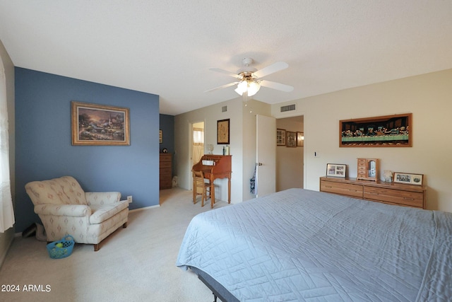 bedroom featuring a ceiling fan, light colored carpet, and visible vents