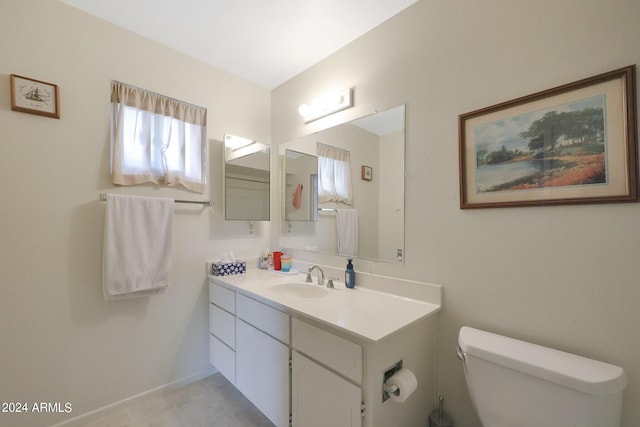 half bath featuring toilet, vanity, and a wealth of natural light