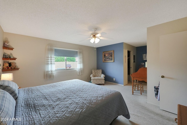 bedroom featuring baseboards, a ceiling fan, a textured ceiling, and light colored carpet