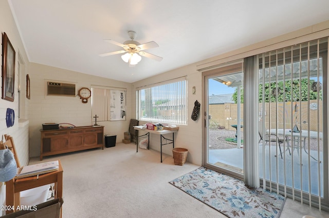 entryway with a wall unit AC, carpet, and a ceiling fan