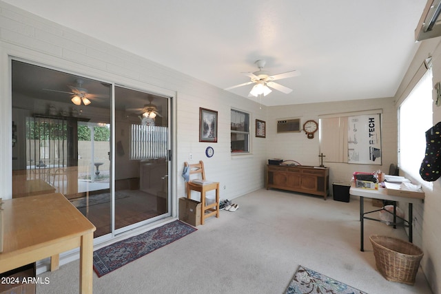 interior space with a wealth of natural light, an AC wall unit, and ceiling fan