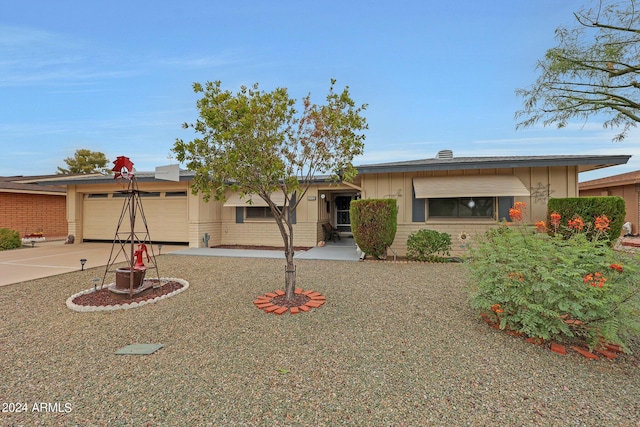 single story home featuring driveway, brick siding, and an attached garage