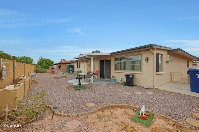 view of front of property with a patio area and a fenced backyard